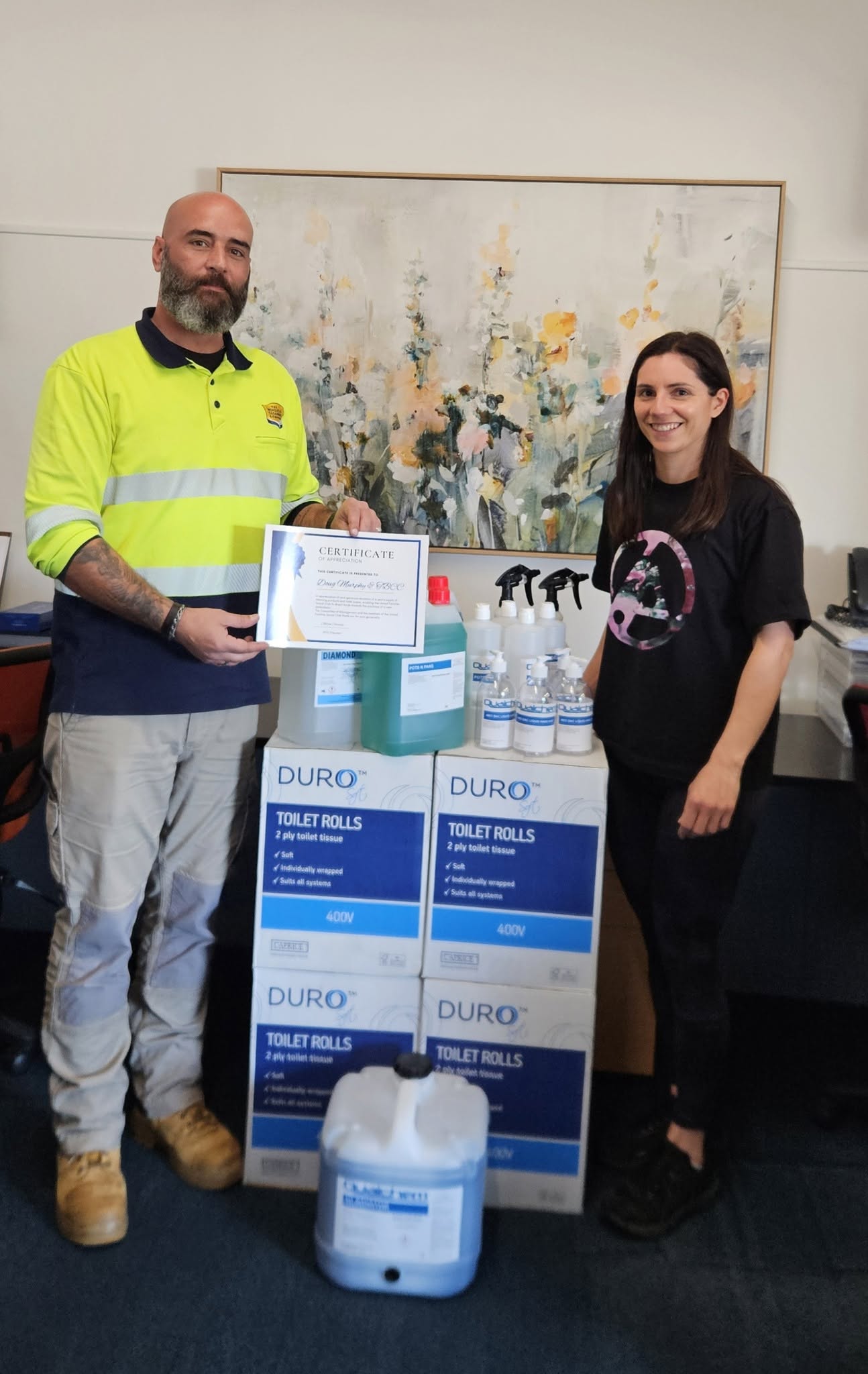 Doug Murphy of The Bendigo Cleaning Company with donated cleaning supplies and a certificate of appreciation from the United Families Social Club